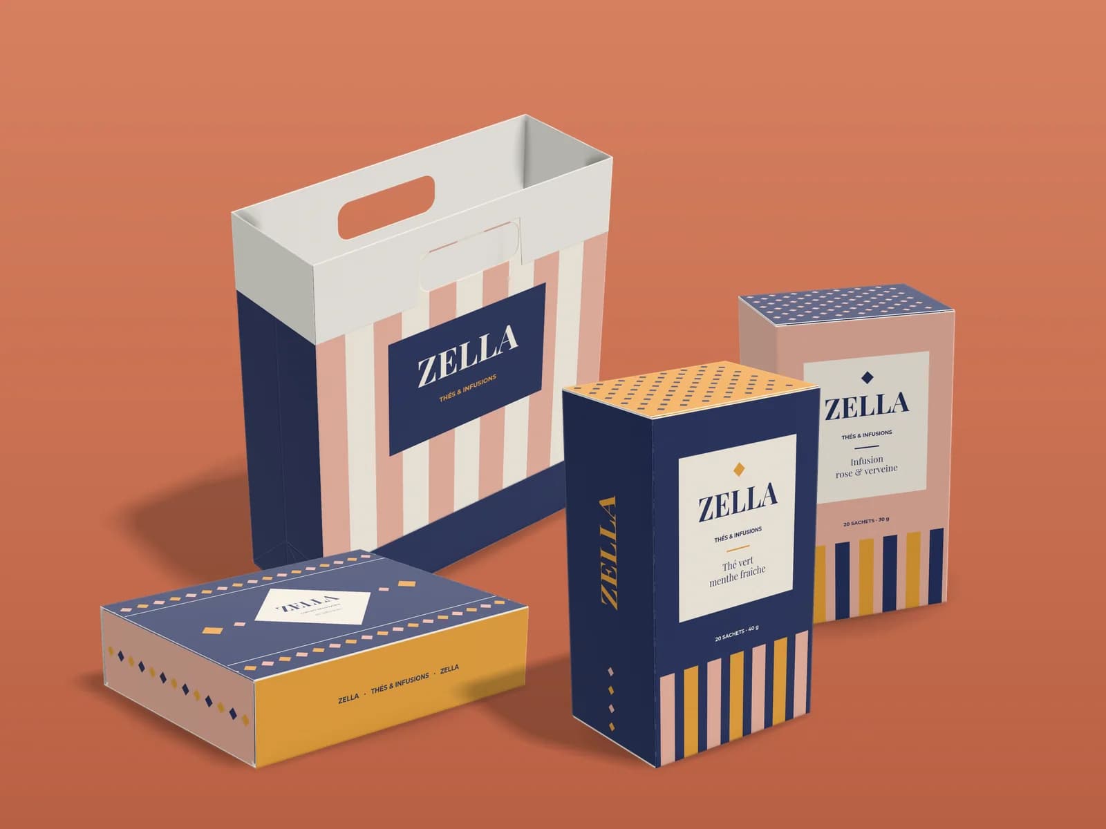 Collection for the fictional tea brand Zella on a terracotta background: a pink and cream striped gift bag, a drawer box with a diamond mosaic, and two indigo and pink folding cartons with the same color bands.